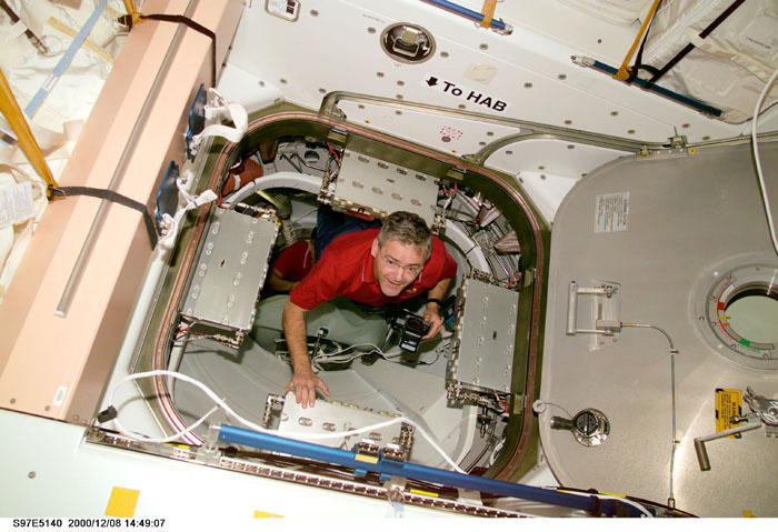 S97-E-5140 (8 December 2000)  --- Astronaut Marc Garneau, with a camera in hand, floats in the hatchway that leads from Unity to Pressurized Mating Adapter-3 (PMA-3), which leads to Endeavour. Garneau,  STS-97 mission specialist representing the Canadian Space Agency (CSA), and his four crew mates went into the International Space Station (ISS) following hatch opening.  The photograph was taken with a digital still camera.