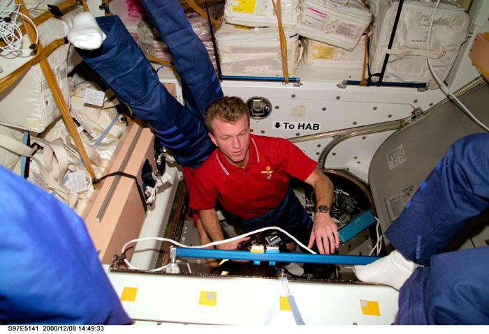 S97-E-5141 (8 December 2000)  --- Astronaut Brent W. Jett, Jr., passes another astronaut going the opposite direction in the hatchway that leads from Unity to Pressurized Mating Adapter-3 (PMA-3), which leads to Endeavour.  Jett, the STS-97 mission commander, and his four crew mates went into the International Space Station (ISS) following hatch opening.  The photograph was taken with a digital still camera.