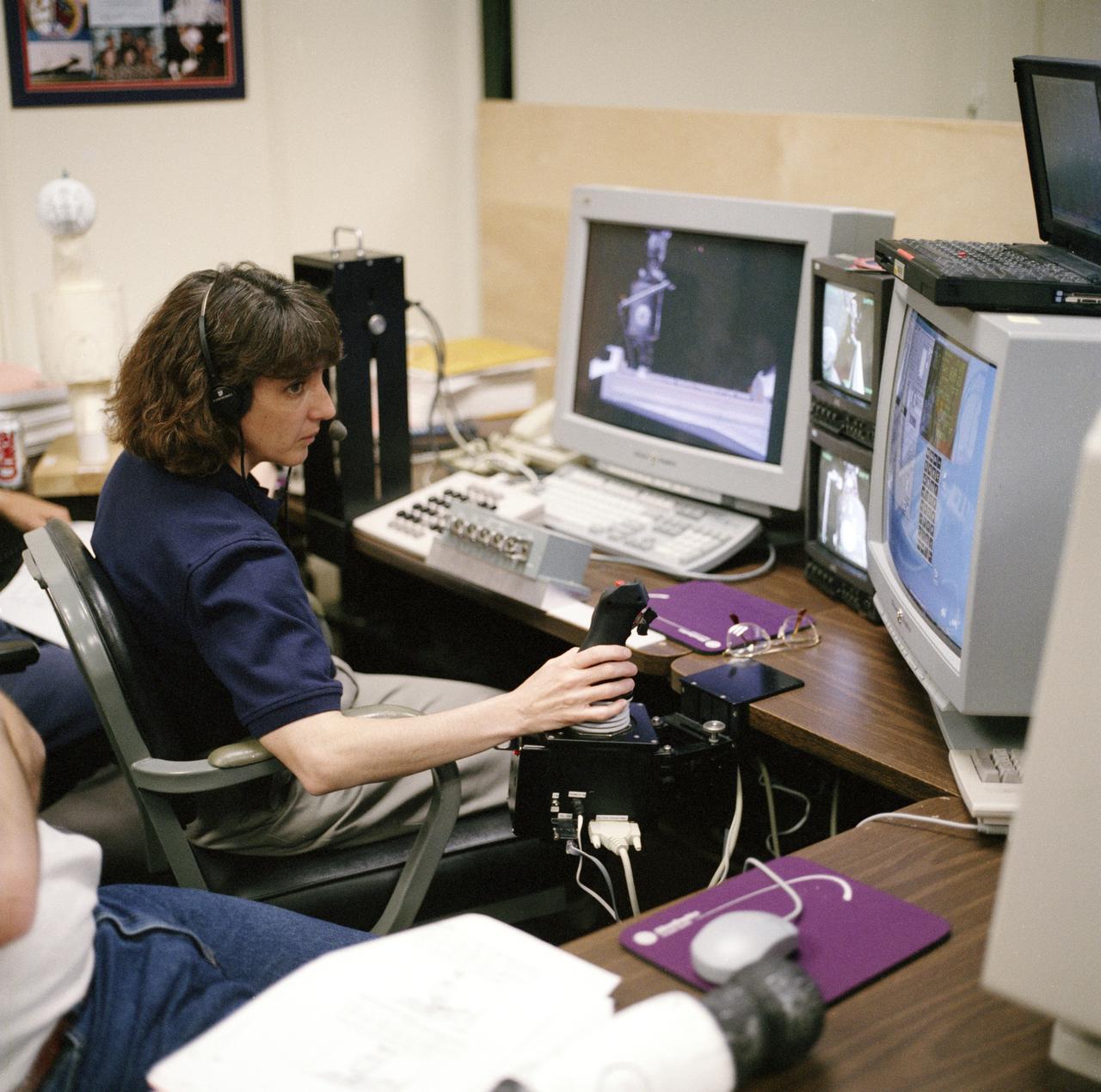 S98-05075 (8 Apr. 1998) --- Astronaut Nancy J. Currie, assigned as a mission specialist for the mission, uses hardware in the virtual reality lab at the Johnson Space Center (JSC) to train for her duties aboard the Space Shuttle Endeavour.  This type computer interface paired with virtual reality training hardware for the assigned space-walking astronauts -- in this case, Jerry L. Ross and James H. Newman -- helps to prepare the entire team for dealing with International Space Station (ISS) elements.  One of those elements will be the Functional Cargo Block (FGB), which will have been launched a couple of weeks prior to STS-88.  Once the FGB is captured using the Remote Manipulator System (RMS) of the Endeavour, Currie will maneuver the robot arm to dock the FGB to the conical mating adapter at the top of Node 1, to be carried in the Endeavour?s cargo bay.  In ensuing days, three Extravehicular Activity?s (EVA) by Ross and Newman will be performed to make power, data and utility connections between the two modules.