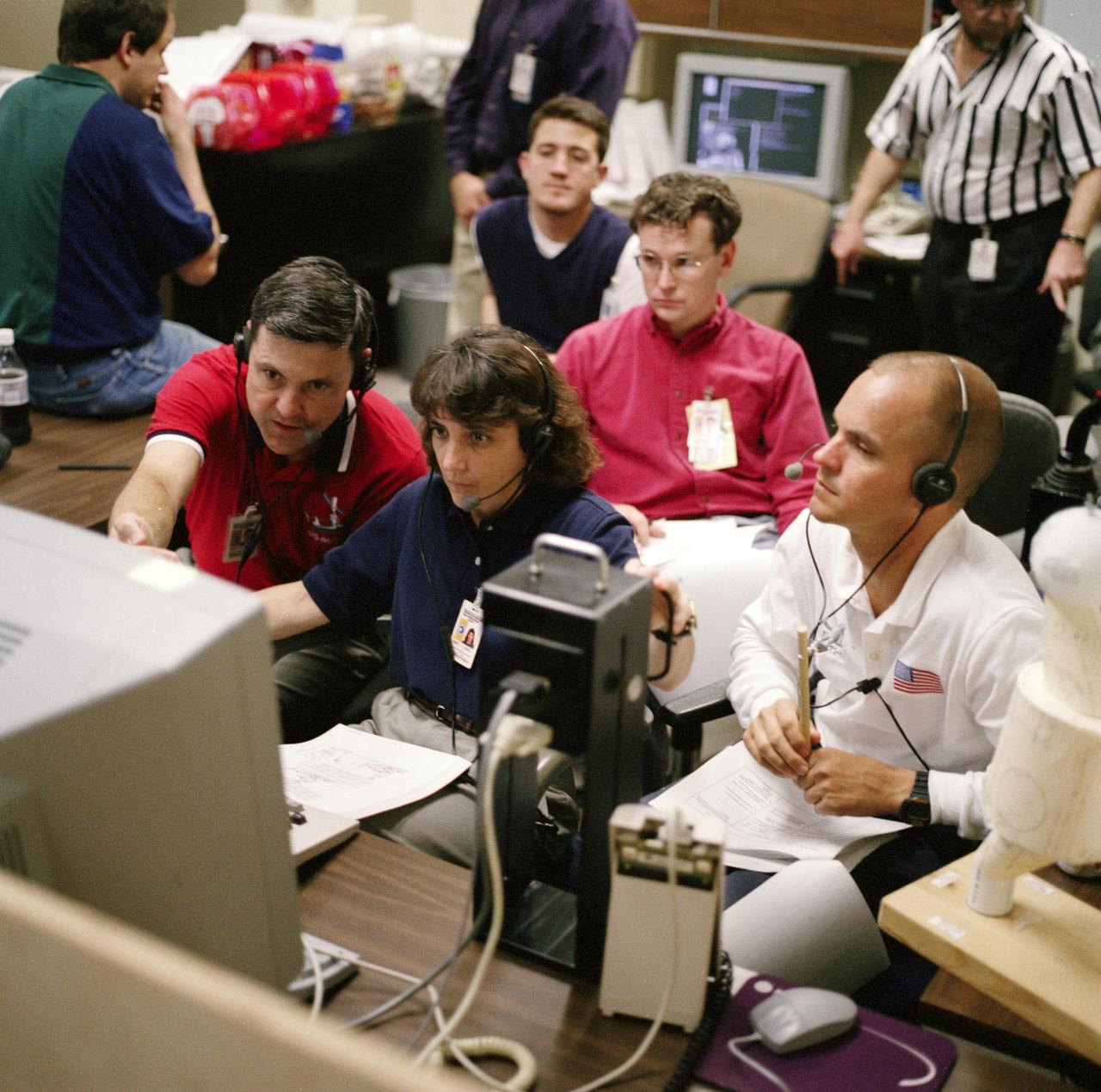 S98-05078 (8 Apr. 1998) --- With crew mates looking on, astronaut Nancy J. Currie, mission specialist, uses hardware in the virtual reality lab at the Johnson Space Center (JSC) to train for her duties aboard the Space Shuttle Endeavour.  She is flanked by astronaut Robert Cabana (left), commander; and Frederick W. Sturckow (right), pilot.  This type computer interface paired with virtual reality training hardware for the assigned space-walking astronauts -- Jerry L. Ross and James H. Newman -- helps to prepare the entire team for dealing with International Space Station (ISS) elements.  One of those elements will be the Functional Cargo Block (FGB), which will have been launched a couple of weeks prior to STS-88.  Once the FGB is captured using the Remote Manipulator System (RMS) of the Endeavour, Currie will maneuver the robot arm to dock the FGB to the conical mating adapter at the top of Node 1, to be carried in the Endeavour's cargo bay.  In ensuing days, three Extravehicular Activity?s (EVA) by Ross and Newman will be performed to make power, data and utility connections between the two modules.  Looking on is Scott A. Bleisath (behind Currie), with the EVA Systems Group at JSC.