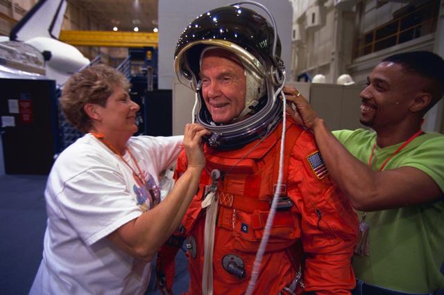 S98-06936 (28 April 1998) --- U.S. Sen. John H. Glenn Jr. (D.-Ohio), is assisted by suit experts Jean Alexander and Carlous Gillis prior to a training session at the Johnson Space Center (JSC). The STS-95 crew members are getting prepared for a scheduled Oct. 29 launch aboard the Space Shuttle Discovery. The photo was taken by Joe McNally, National Geographic, for NASA.