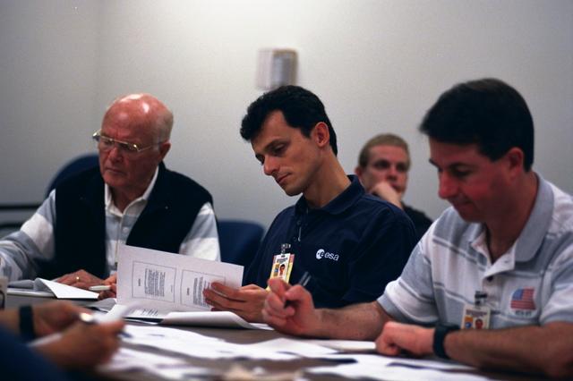 S98-06947 (28 April 1998)--- Three crewmembers for the STS-95 mission take notes during a class room session in preparation for the scheduled October 1998 flight. From the left are U.S. Sen. John H. Glenn Jr.(D.-Ohio), Pedro Duque and Stephen K. Robinson. Duque represents the European Space Agency (ESA). Photo Credit: Joe McNally, National Geographic, for NASA.