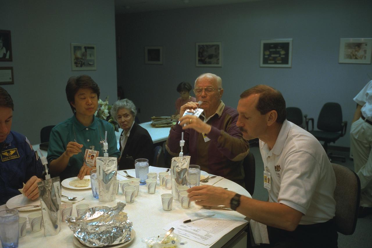 S98-08729 (9 April 1998) --- Four members of the STS-95 crew participate in a food tasting session at the Johnson Space Center (JSC).  From the left are Stephen K. Robinson, mission specialist; payload specialist Chiaki Mukai of Japan's National Space Development Agency (NASDA); U.S. Sen. John H. Glenn Jr., payload specialist; and Curtis L. Brown Jr., mission commander. They will be joined by three other astronauts when Discovery lifts off in late October of this year for a scheduled nine-day mission.  The photo was taken by Joe McNally, National Geographic, for NASA.