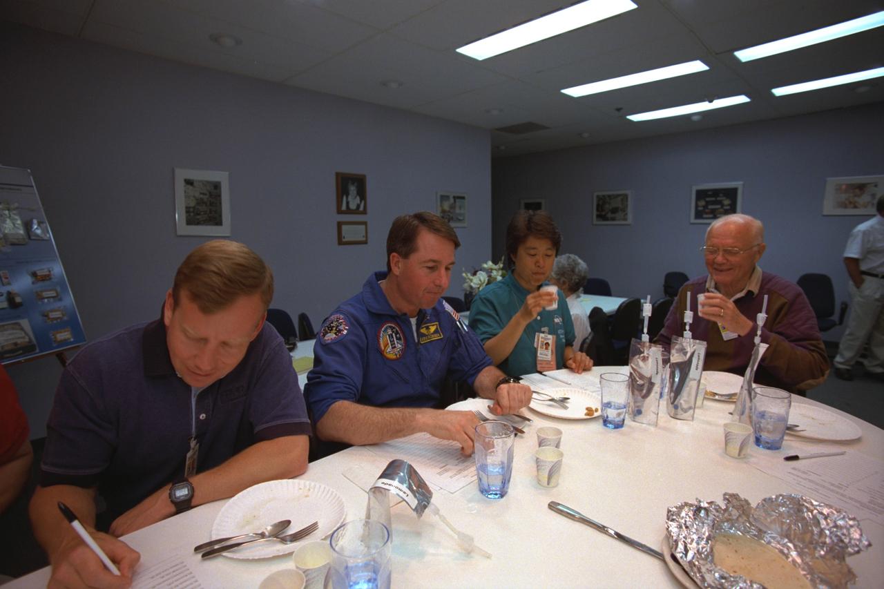 S98-08731 (9 April 1998) --- Four members of the STS-95 crew participate in a food tasting session at the Johnson Space Center (JSC). From the left are Steven W. Lindsey, pilot; Stephen K. Robinson, mission specialist; with payload specialists Chiaki Mukai of Japan's National Space Development Agency (NASDA) and U.S. Sen. John H. Glenn Jr. They will be joined by three other astronauts when Discovery lifts off in late October of this year for a scheduled nine-day mission. The photo was taken by Joe McNally, National Geographic, for NASA.