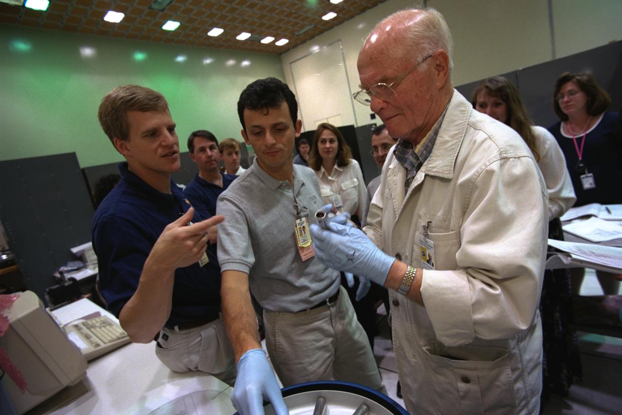 S98-08741 (May 1998) --- Three crew members in training for the STS-95 mission check out a training version of a blood centrifuge that will accompany them aboard the Space Shuttle Discovery later this year. In the foreground (from the left), are astronauts Scott E. Parazynski and Pedro Duque, both mission specialists, and U.S. Sen. John H. Glenn Jr., payload specialist. Duque, representing the European Space Agency (ESA), has his right hand on the centrifuge.  Sen. Glenn holds a vial of blood that would be placed inside the centrifuge. Among those in the background is astronaut Stephen K. Robinson (left side of frame), STS-95 mission specialist. The photo was taken by Joe McNally, National Geographic, for NASA.