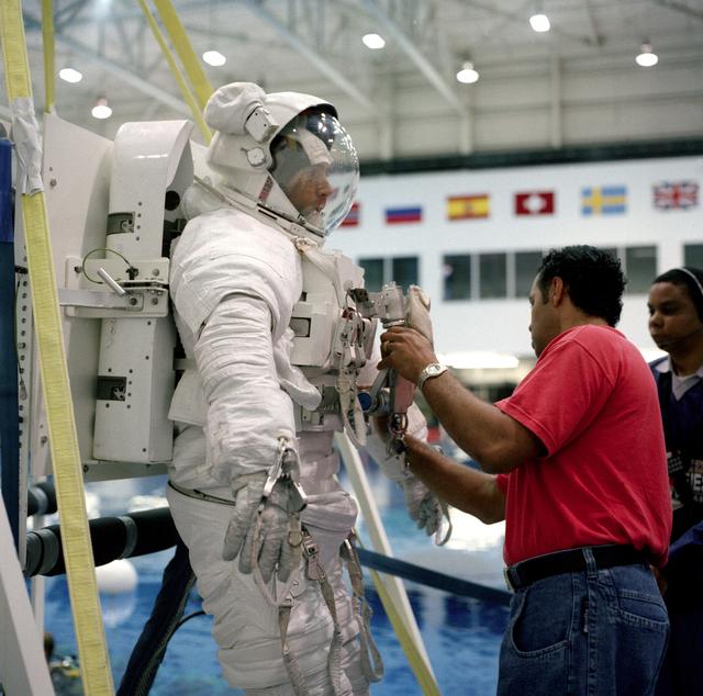 NASA image: STS-88 crewmen don Extravehicular Mobility Units