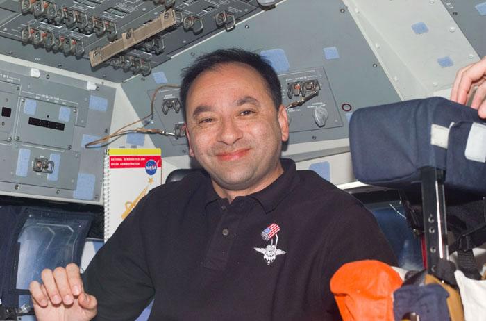 STS98-E-5002 (8 February 2001) -- Astronaut Mark L. Polansky, STS-98 pilot, is seen on the flight deck of the Earth-orbiting Space Shuttle Atlantis in one of the first digital still camera scenes to be down linked from the shuttle.