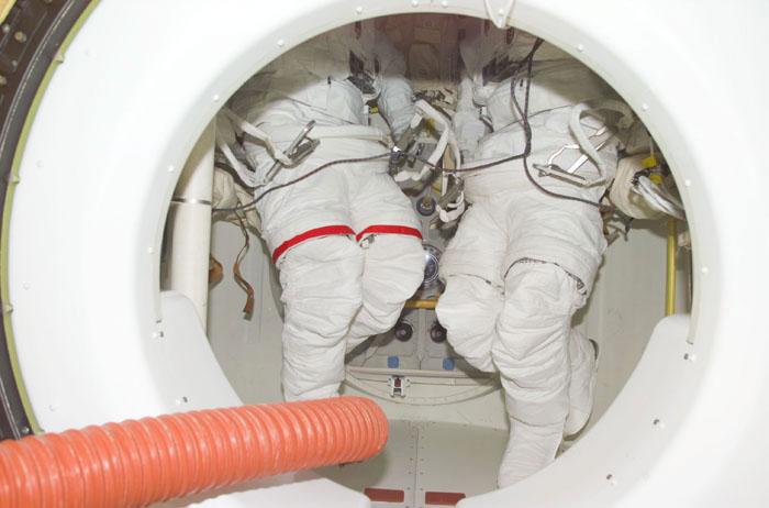 STS98-E-5012 (8 February 2001) --- The bottom portions of the extravehicular mobility units (EMU) for STS-98's two space walkers are seen in the airlock aboard the Space Shuttle Atlantis during early stages of the STS-98 mission. Astronaut Thomas D. Jones will be using the suit on the left, and astronaut Robert L. Curbeam will don the one on the right. The two mission specialists are scheduled for extravehicular activity (EVA) once the shuttle is docked with the International Space Station (ISS) later in the week. The scene was recorded with a digital still camera.