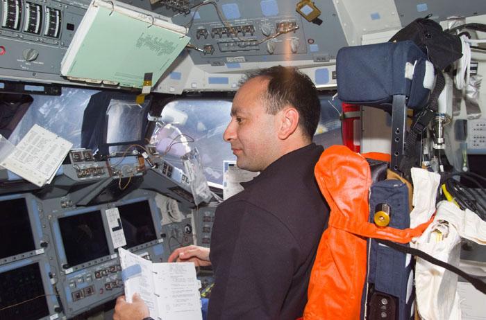 STS98-E-5015 (8 February 2001) --- Astronaut Mark L. Polansky, pilot, is pictured at the pilot's station on the flight deck of the Space Shuttle Atlantis during Flight Day 1.  The scene was recorded with a digital still camera.