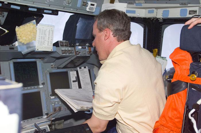 STS98-E-5027 (9 February 2001) --- Astronaut Thomas D. Jones, mission specialist, temporarily mans the pilot's station on the flight deck of the Space Shuttle Atlantis during STS-98 Flight Day 2 maneuvers. The photograph was recorded with a digital still camera.