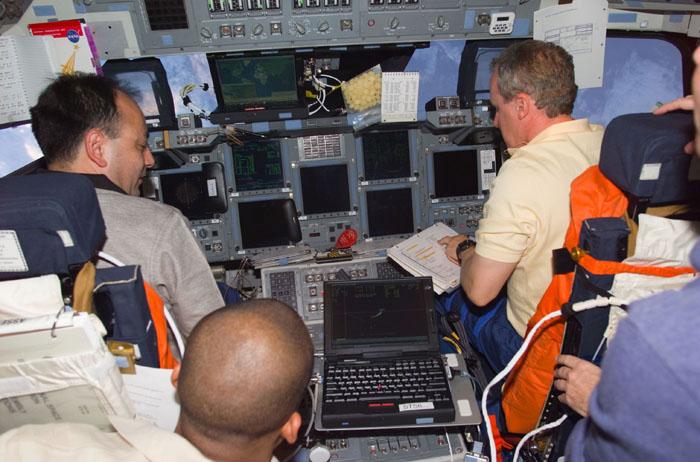 STS98-E-5030 (9 February 2001) --- Three members of the STS-98 crew prepare for rendezvous with the International Space Station (ISS). Astronaut Thomas D. Jones (right), mission specialist, temporarily mans the pilot's station on the flight deck of the Space Shuttle Atlantis.  Astronaut Mark L. Polansky, left, sits at the commander's station for this maneuver.  At lower left is Astronaut Robert L. Curbeam, mission specialist.  Astronaut Kenneth D. Cockrell, mission commander, is just out of frame at right. The photograph was recorded with a digital still camera.