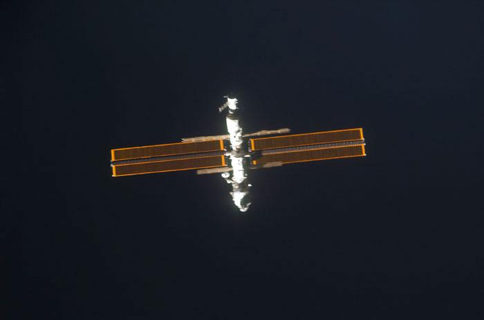 STS98-E-5031 (9 February 2001) --- International Space Station (ISS) is backdropped against the blackness of space as Space Shuttle Atlantis approaches.  The scene was recorded with a digital still camera by one of the STS-98 astronauts aboard the shuttle.