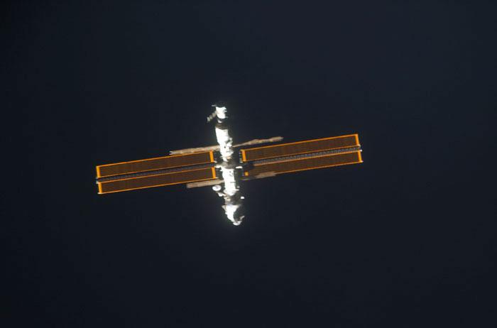 STS98-E-5032 (9 February 2001) --- International Space Station (ISS) is backdropped against the blackness of space as Space Shuttle Atlantis approaches.  The scene was recorded with a digital still camera by one of the STS-98 astronauts aboard the shuttle.