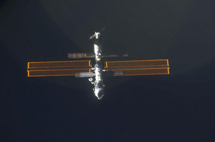 STS98-E-5033 (9 February 2001) --- International Space Station (ISS) is backdropped against the blackness of space as Space Shuttle Atlantis approaches.  The scene was recorded with a digital still camera by one of the STS-98 astronauts aboard the shuttle.