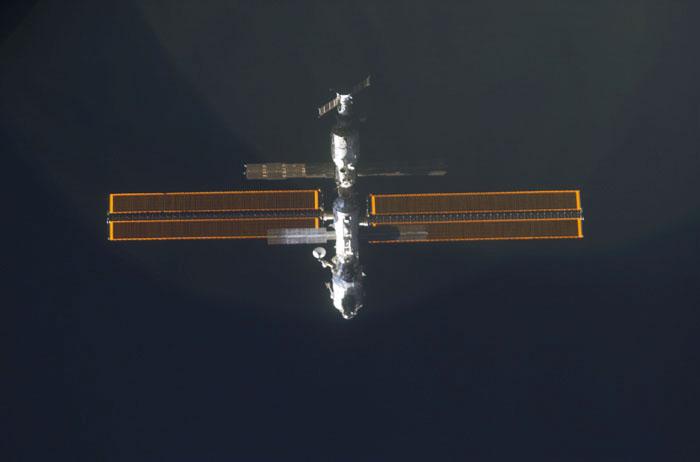 STS98-E-5034 (9 February 2001) --- International Space Station (ISS) is backdropped against the blackness of space as Space Shuttle Atlantis approaches.  The scene was recorded with a digital still camera by one of the STS-98 astronauts aboard the shuttle.