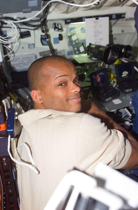 STS98-E-5038 (9 February 2001) --- Astronaut Robert L. Curbeam, mission specialist, stays busy at a makeshift supply depot on the flight deck of the Space Shuttle Atlantis during rendezvous and docking operations with the International Space Station (ISS). The scene was recorded with a digital still camera.