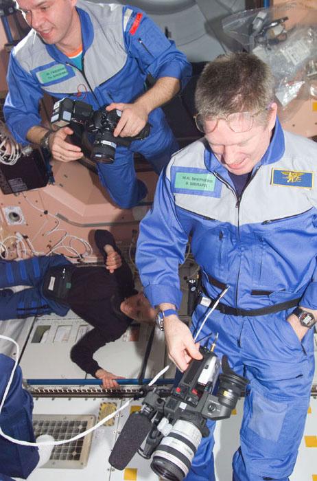 STS98-E-5047 (9 February 2001) --- Two Expedition One crew members prepare to greet and photograph their newest visitors aboard the International Space Station (ISS) soon after the STS-98 astronauts opened the hatches and paid a visit to the station. Astronaut William M. (Bill) Shepherd, Expedition One commander, is in right foreground; and cosmonaut Yuri P. Gidzenko, Soyuz commander, is at left.   This scene was recorded with a digital still camera.