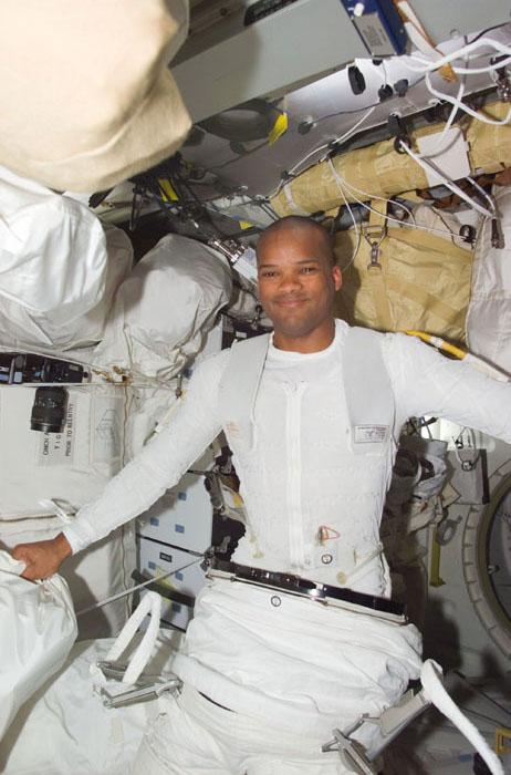 STS98-E-5075 (10 February 2001) --- Pictured on the mid deck the Space Shuttle Atlantis, astronaut Robert L. Curbeam,  STS-98 mission specialist, will be repeating this scene of suit donning (and doffing) a number of times as he will be participating in three separate space walks during the ISS 5a flight. The scene was recorded with a digital still camera during Flight Day 4 activity.