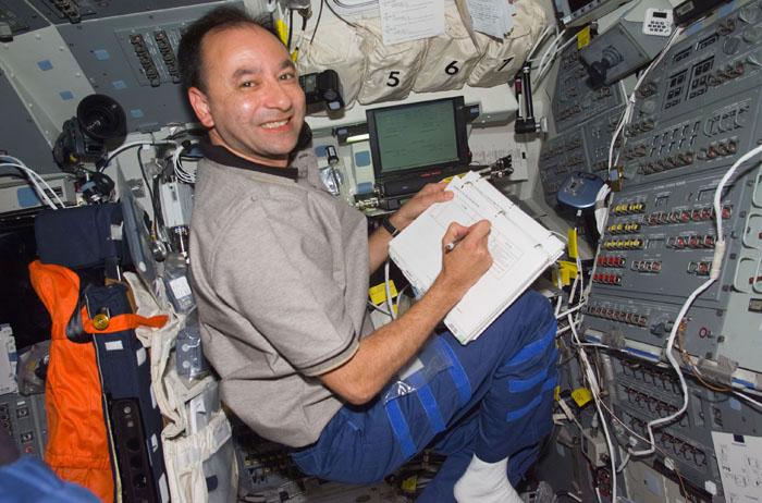 STS98-E-5084 (10 February 2001) --- Astronaut Mark L. Polansky, STS-98 pilot, takes notes on the aft flight deck of the Space Shuttle Atlantis. The scene was recorded with a digital still camera during Flight Day 4 activities.