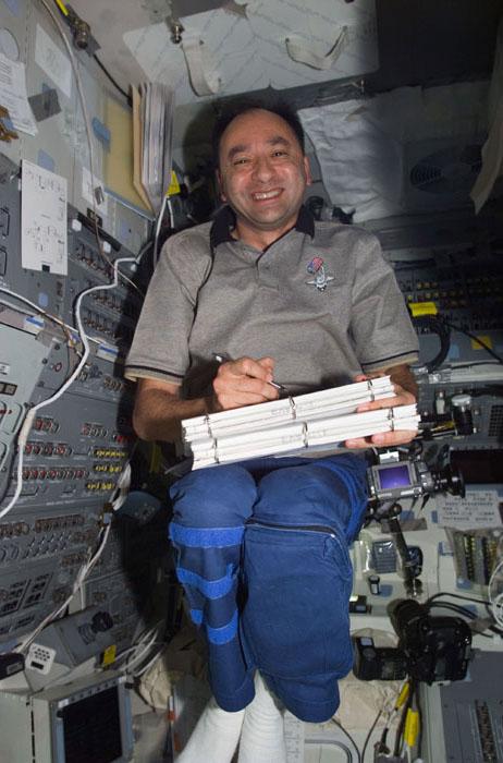 S98-E-5085 (10 February 2001) --- Astronaut Mark L. Polansky, STS-98 pilot, makes marginal notes on flight procedures tablets on the aft flight deck of the Space Shuttle Atlantis. The scene was recorded with a digital still camera during Flight Day 4 activities.