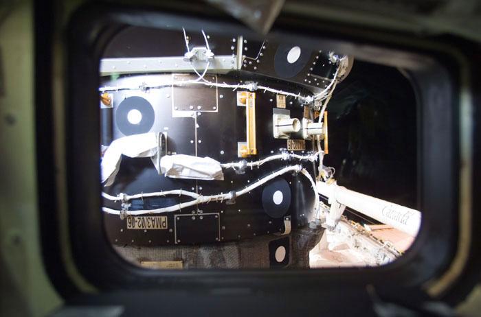 STS98-E-5091 (10 February 2001) --- One of the International Space Station's Pressurized Mating Adapters (PMA-3) was photographed with a digital still camera from the crew cabin of the Space Shuttle Atlantis during Flight Day 4 activity. The Canadian-built Remote Manipulator System (RMS) arm can be seen   in its stowed position on the port side of the shuttle's cargo bay.