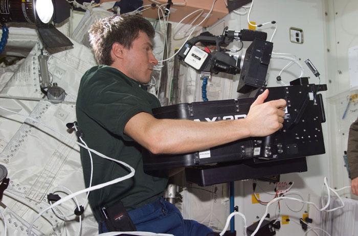 STS98-E-5124 (11 February 2001) --- Cosmonaut Sergei K. Krikalev, Expedition One flight engineer representing the Russian Aviation and Space Agency,  films activity in the Unity node, just outside the newly attached Destiny laboratory. The crews of Atlantis and the International Space Station on February 11 opened the Destiny laboratory and spent the first full day of what are planned to be years of work ahead inside the orbiting science and command center. Astronaut William M. (Bill) Shepherd (just out of frame here) opened the Destiny hatch, and he and Shuttle commander Kenneth D. Cockrell ventured inside at 8:38 a.m. (CST).  Members of both crews went to work quickly inside the new module, activating air systems, fire extinguishers, alarm systems, computers and internal communications. The crew also continued equipment transfers from the shuttle to the station and filmed several scenes onboard the station using the IMAX camera. This scene was recorded with a digital still camera.