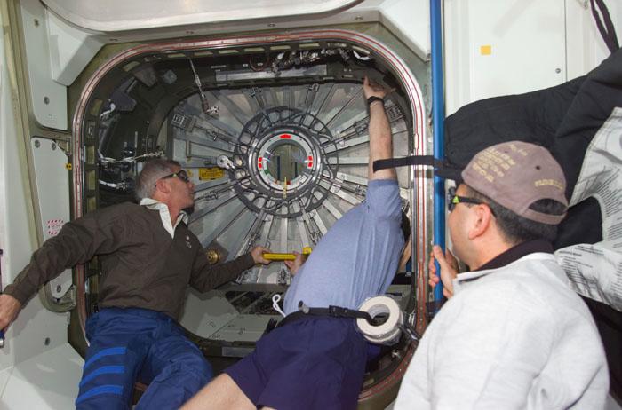 STS98-E-5131 (11 February 2001) --- The crews of Atlantis and the International Space Station open the Destiny laboratory on February 11 in this digital still camera view.  From the left are astronauts Kenneth D. Cockrell, STS-98 commander; William M. (Bill) Shepherd, Expedition One commander; and  Mark L. Polansky, STS-98 pilot. Later, the astronauts and cosmonauts spent the first full day of what are planned to be years of work ahead inside the orbiting science and command center. After Shepherd opened the Destiny hatch, he and Cockrell ventured inside at 8:38 a.m. (CST).  As depicted in subsequent digital images in this series, members of both crews went to work quickly inside the new module, activating air systems, fire extinguishers, alarm systems, computers and internal communications. The crew also continued equipment transfers from the shuttle to the station.