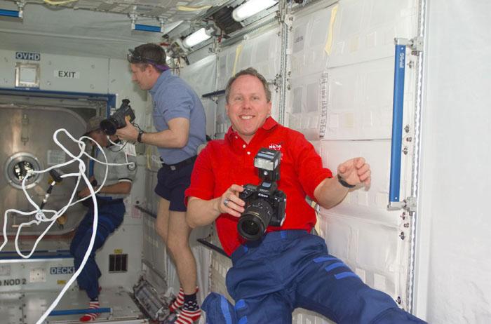 STS98-E-5137 (11 February 2001) --- Astronauts Thomas D. Jones (foreground), STS-98 mission specialist,  and William M. Shepherd, Expedition One mission commander, participate in an impromptu photo shoot onboard the newly opened Destiny laboratory on the International Space Station (ISS).  After Shepherd opened the Destiny hatch, he and astronaut Kenneth D. Cockrell (out of frame) ventured inside at 8:38 a.m. (CST), February 11, 2001.  As depicted in subsequent digital images in this series, members of both crews went to work quickly inside the new module, activating air systems, fire extinguishers, alarm systems, computers and internal communications. The crew also took some photos and continued equipment transfers from the shuttle to the station.
