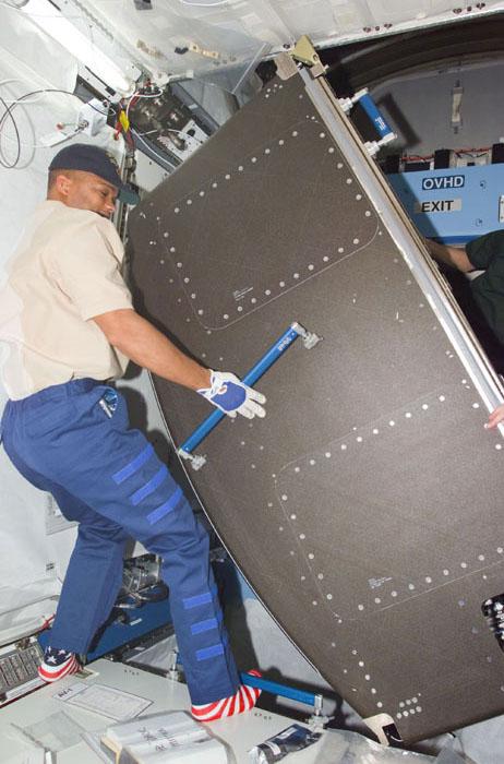 STS98-E-5157 (11 February 2001) ---  Astronaut Robert L. Curbeam, STS-98 mission specialist, installs some of the fixtures in the newly attached Destiny  laboratory onboard the International Space Station (ISS).  After the Destiny hatch was opened early in the day, members of both crews went to work quickly inside the new module, activating air systems, fire extinguishers, alarm systems, computers and internal communications. The crews also took some photos and continued equipment transfers from the shuttle to the station. The scene was taken with a digital still camera.