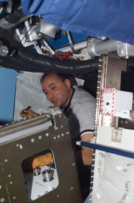 STS98-E-5159 (11 February 2001) ---  Astronaut Mark L. Polansky, STS-98 pilot, works inside the newly attached Destiny laboratory onboard the International Space Station (ISS).  After the Destiny hatch was opened early in the day, members of both the shuttle and station crews went to work quickly inside the new module, activating air systems, fire extinguishers, alarm systems, computers and internal communications. The crews also took some photos and continued equipment transfers from the shuttle to the station. The scene was taken with a digital still camera.