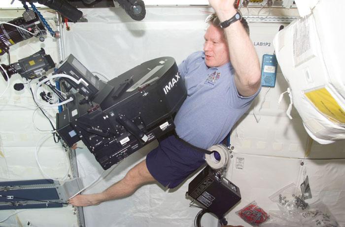 STS98-E-5164 (11 February 2001) --- Astronaut William M. (Bill) Shepherd documents activity onboard the newly attached Destiny laboratory using an IMAX motion picture camera. The crews of Atlantis and the International Space Station on February 11 opened the Destiny laboratory and spent the first full day of what are planned to be years of work ahead inside the orbiting science and command center. Shepherd opened the Destiny hatch, and he and Shuttle commander Kenneth D. Cockrell ventured inside at 8:38 a.m. (CST).  Members of both crews went to work quickly inside the new module, activating air systems, fire extinguishers, alarm systems, computers and internal communications. The crew also continued equipment transfers from the shuttle to the station and filmed several scenes onboard the station using an IMAX camera. This scene was recorded with a digital still camera.