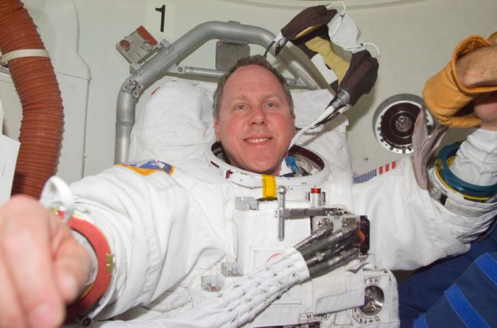 STS98-E-5176 (12 February 2001) --- Astronaut Thomas D. Jones, STS-98 mission specialist, dons his extravehicular mobility unit for the upcoming space walk on the International Space Station on February 12.  This scene was recorded with a digital still camera.