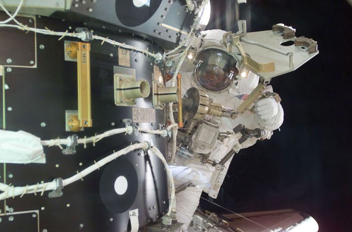 STS98-E-5191 (12 February 2001) --- Astronaut Robert L. Curbeam, STS-98 mission specialist, is pictured near Pressurized Mating Adapter (PMA-3) during the second of three scheduled space walks on 5a. The scene was recorded with a digital still camera.