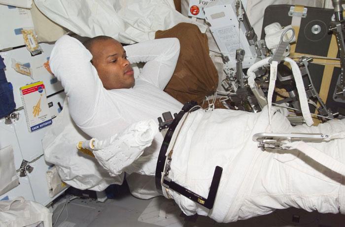 SS98-E-5214 (14 February 2001) --- Astronaut Robert L. Curbeam, STS-98 mission specialist, dons his extravehicular mobility unit (EMU) for the final of three space walks he shared with astonaut Thomas D. Jones on mission 5a.  The scene was recorded with a digital still camera.