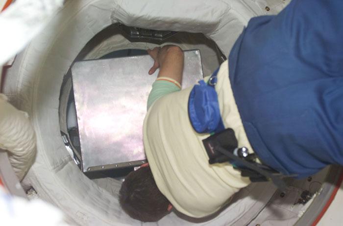 STS098-E-5241 (15 February 2001) --- An Expedition One crew member attempts to transfer the Vozdukh from the Space Shuttle Atlantis to the International Space Station (ISS). Vozdukh is the Russian system in the Zvezda Service Module, which removes carbon dioxide from the ISS atmosphere. The scene was recorded with a digital still camera by one of the STS-98 astronauts aboard the shuttle.
