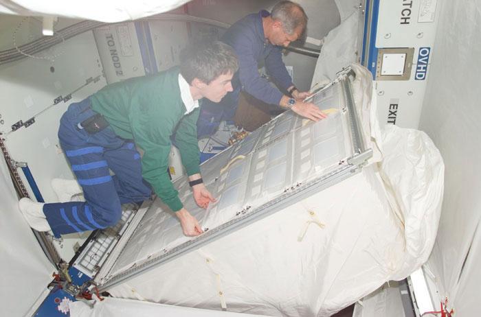 STS98-E-5250 (15 February 2001) --- Astronaut Kenneth D. Cockrell (left), STS-98 mission commander, teams with cosmonaut Sergei K. Krikalev, Expedition One flight engineer in setting up hardware aboard the newly opened Destiny  laboratory onboard the International Space Station (ISS). This photo was recorded with a digital still camera.