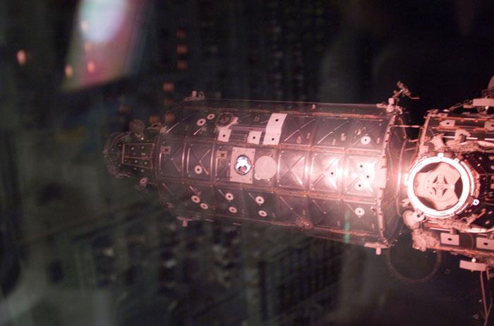 STS98-E-5304 (16 February 2001) ---   The faces of some members of the Expedition One crew can be seen in the window of the newly attached Destiny laboratory as the International Space Station (ISS) and the Space Shuttle Atlantis (from which the digital still was taken) begin their relative separation.