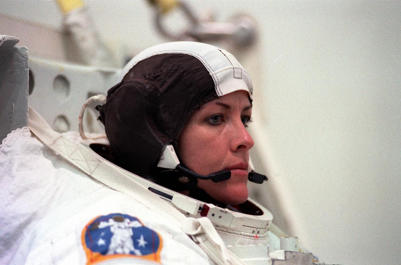 S99-05718 (26 May 1999) --- Astronaut Janet L. Kavandi, mission specialist, checks her communications head gear as she stands on a movable platform.  Minutes later she was lowered into a nearby deep pool for an underwater training session at the Johnson Space Center's Neutral Buoyancy Laboratory (NBL), part of the Sonny Carter Training Center.  Kavandi has weights on the training version of her extravehicular mobility unit (EMU) which help to provide neutral buoyancy in the pool.  Astronauts Kavandi and Gerhard P.J. Thiele were participating in a rehearsal of a contingency space walk.