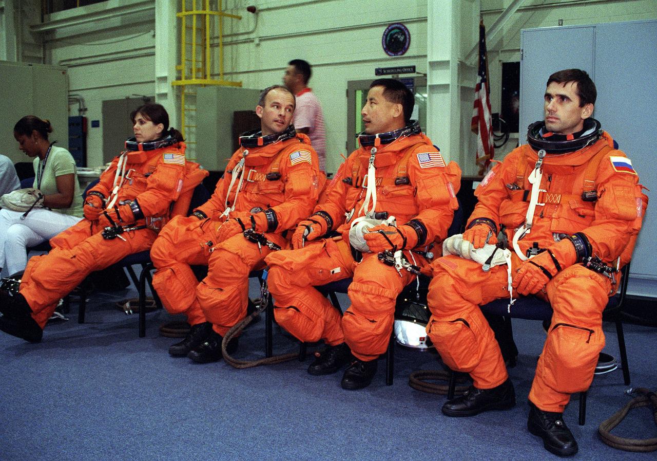 S99-06205 (25 June 1999) --- Three astronauts and a mission specialist representing the Russian Space Agency (RSA) await to be briefed by a member of the crew training staff (out of frame) during an emergency egress training session at the Johnson Space Center's Systems Integration Facility. From the left are astronauts Mary Ellen Weber, Jeffrey N. Williams and Edward T. Lu, along with cosmonaut Yuri I. Malenchenko. This group will join two other astronauts and a second cosmonaut for a scheduled January mission with the International Space Station (ISS).