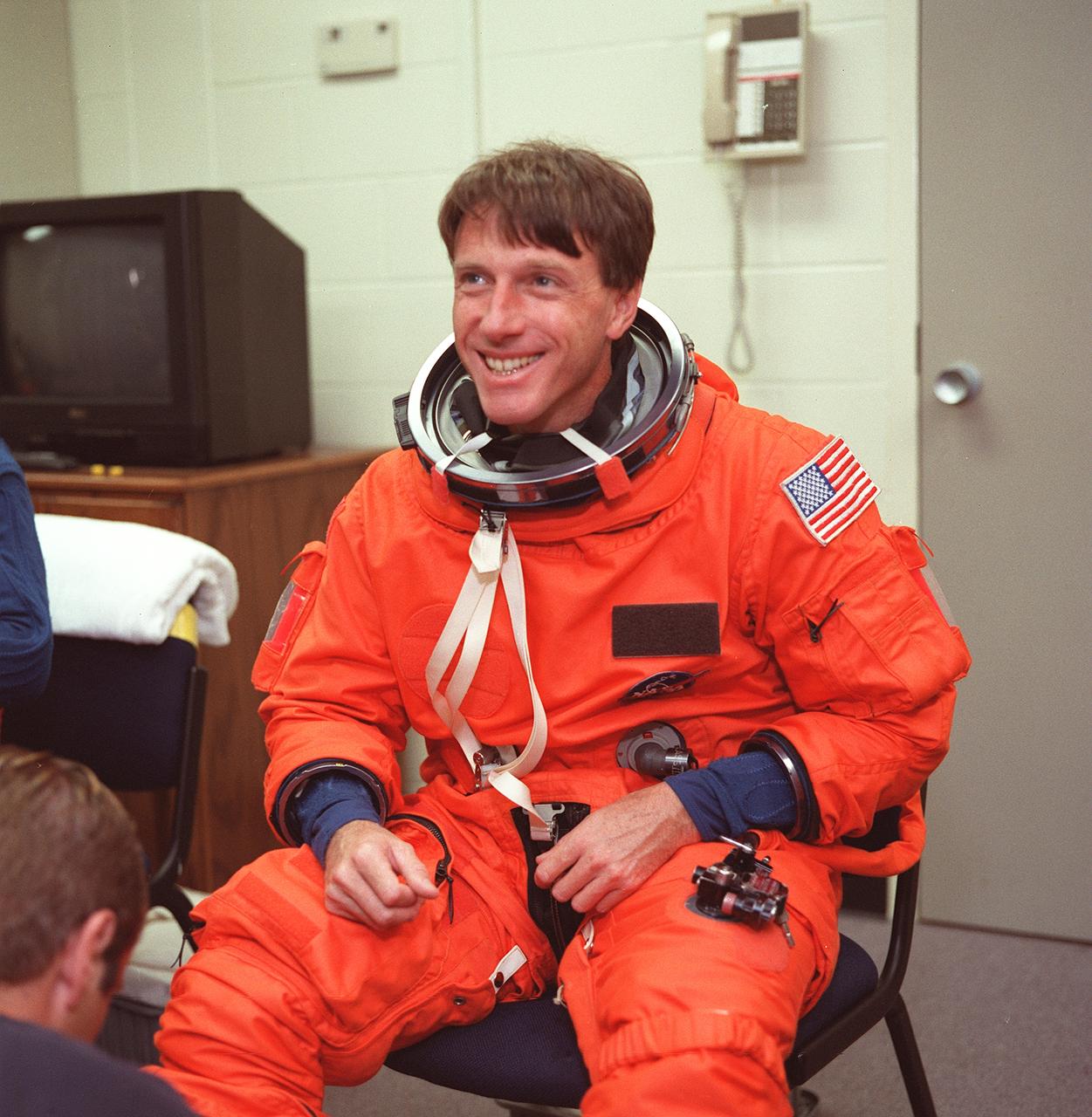 S99-08648 (24 May 1999) --- Suit technicians assist astronaut C. Michael Foale, mission specialist, in readying for a session of emergency bailout training in the Systems Integration Facility at the Johnson Space Center (JSC). Foale, wearing a training version of the partial-pressure launch and entry garment, and his six STS-103 crew mates are currently in training for the third servicing visit to the Hubble Space Telescope (HST) since its 1990 deployment.
