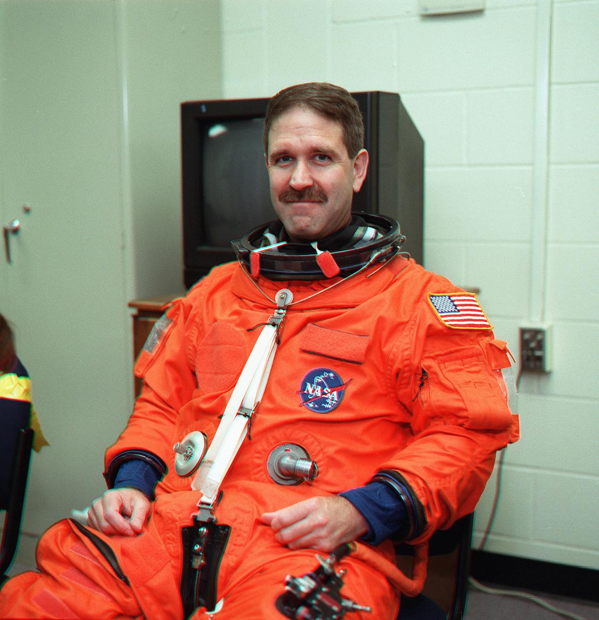 S99-08659 (24 May 1999) --- Astronaut John M. Grunsfeld, STS-103 mission specialist, has just donned a training version of the shuttle launch and entry garment prior to an emergency bailout training session at the Johnson Space Cetner (JSC). Grunsfeld will join six other astronauts for the autumn visit to the Hubble Space Telescope (HST) to participate in NASA third servicing mission on the orbiting observatory.