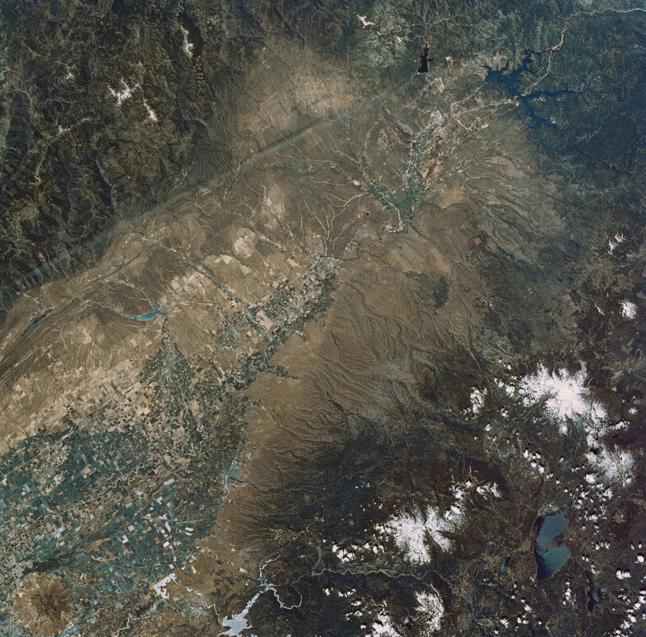 SL2-04-179 (22 June 1973) --- The Sacramento Valley (40.5N, 121.5W) of California is the northern extension of the Central Valley, main agriculture region of the state. Hundreds of truck farms, vineyards and orchards can be seen throughout the length and breadth of the valley which was reclaimed from the desert by means of intensive and extensive irrigation projects. Photo credit: NASA