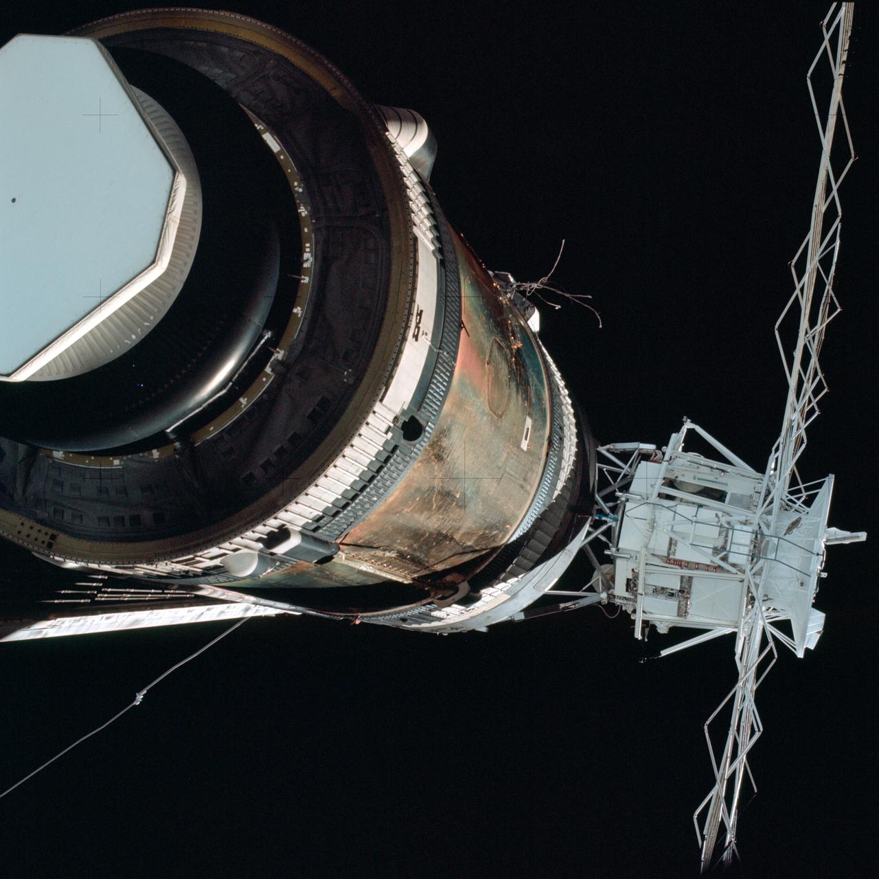 SL2-4-265 (25 May 1973) --- Skylab 2, approach to Skylab at long range, fly-around inspection. Orbital Workshop with area of missing micrometeoroid shield visible and partially deployed solar array visible. Photo credit: NASA