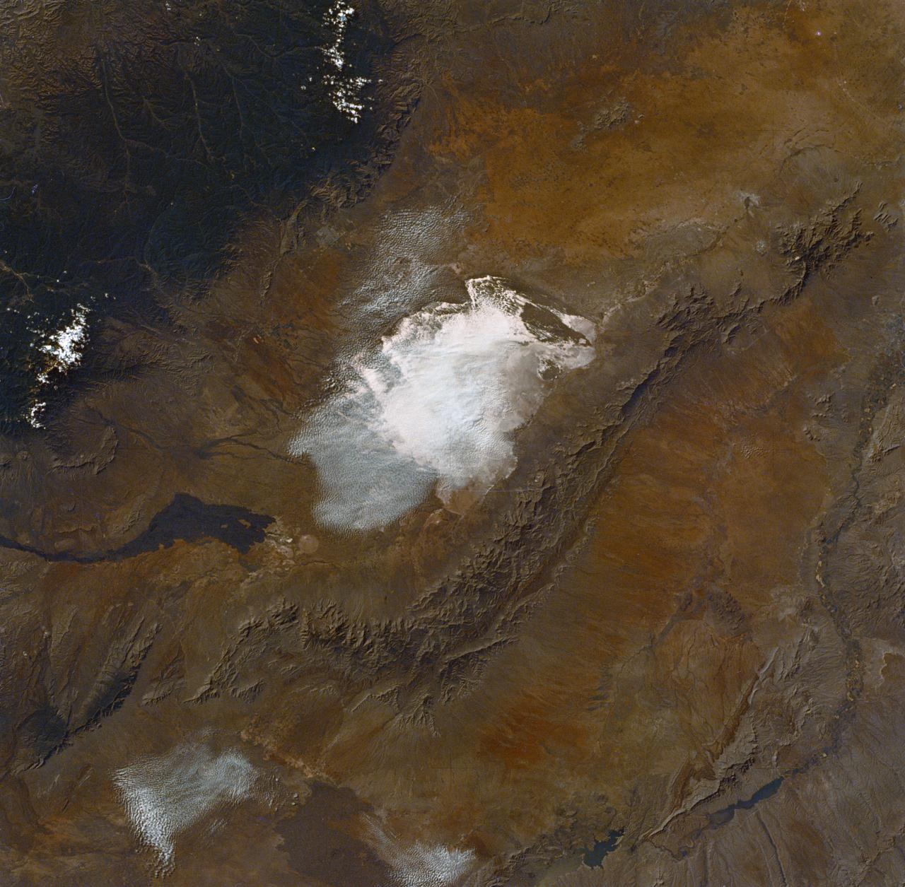 SL2-04-288 (22 June 1973) --- A truly remarkable view of White Sands and the nearby Carrizozo Lava Beds in southeast New Mexico (33.5N, 106.5W). White Sands, site of the WW II atomic bomb development and testing facility and later post war nuclear weapons testing that can still be seen in the cleared circular patterns on the ground. Photo credit: NASA