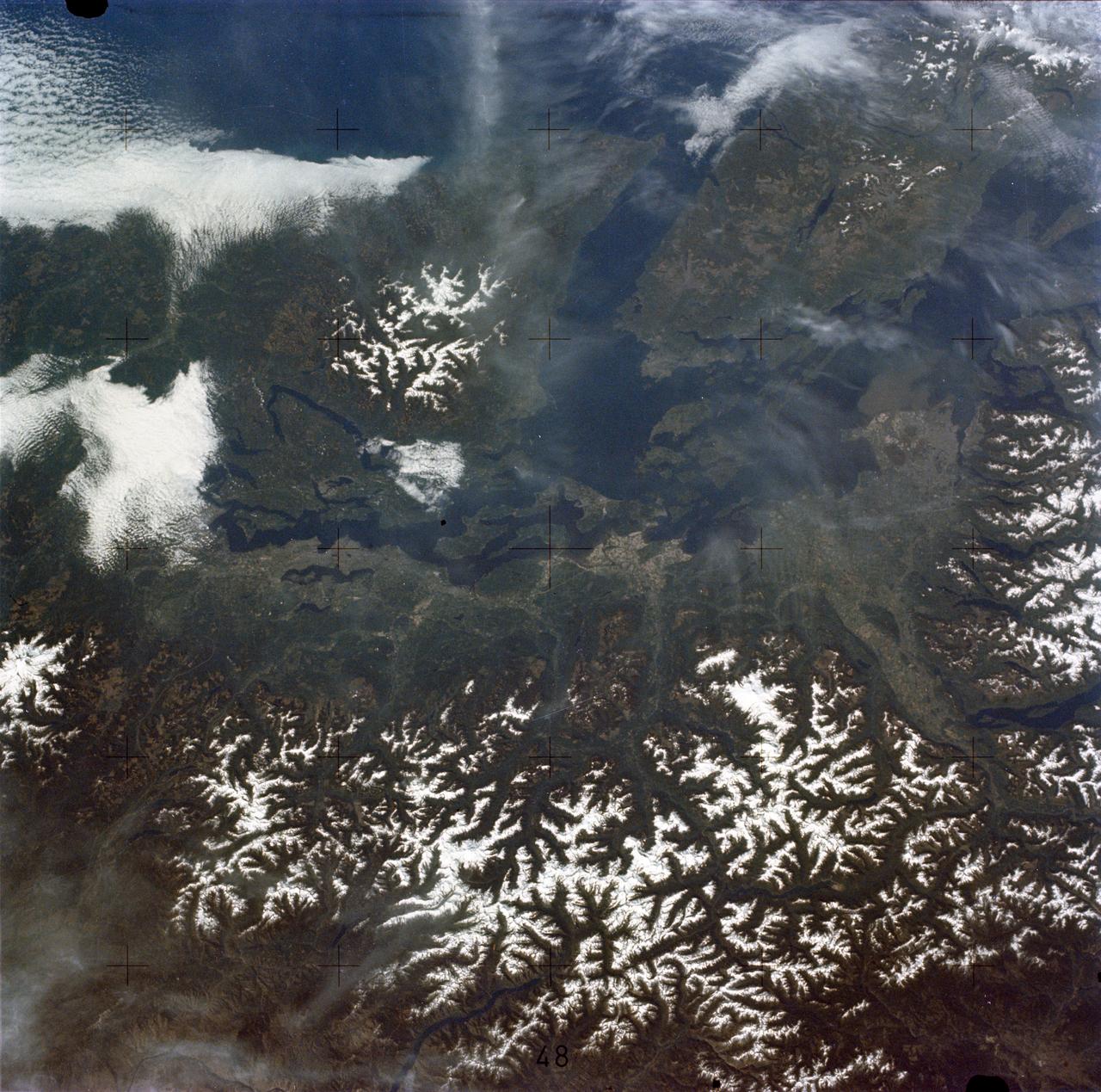SL2-05-458 (22 June 1973) --- Portions of northwest Washington State (48.0N, 122.5) can be seen in this view as well as portions of British Columbia, Canada. The snow covered Cascade Mountains are on the eastern side of the scene. Vancouver Island is visible in the northeast corner of the photo. The strait of Juan de Fuca separates Vancouver Island from the northwest corner of Washington. Seattle is near the center and the snow covered Olympic Mountains are to the east. Photo credit: NASA