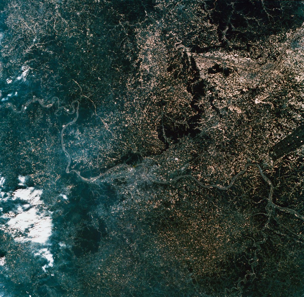SL2-10-260 (22 June 1973) --- The meandering Ohio River bisecting this image is the border between Kentucky and Indiana. Louisville, KY (38.5N, 86.0W) on the south shore, is the main city seen in this predominately agricultural region where much of the native hardwood forests have been preserved in the hilly terrain. The main crops in this region include corn, alfalfa, wheat and soybeans. The dark rectangle in south Indiana near the river is The U.S. Army's Jefferson Proving Ground. Photo credit: NASA