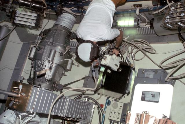View of Astronaut Owen Garriott taking video of two Skylab spiders experiment