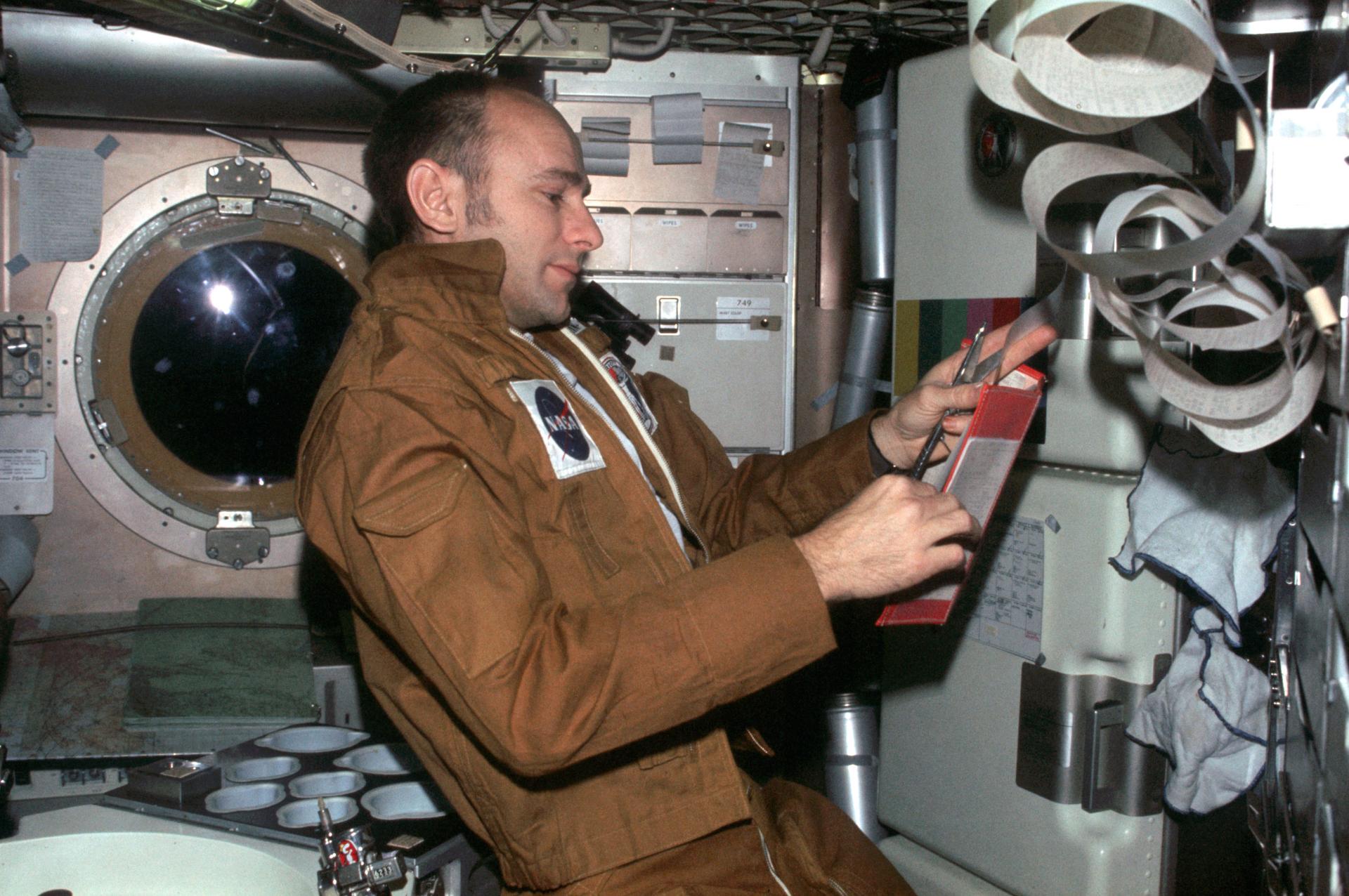 Alan Bean on board Skylab reading