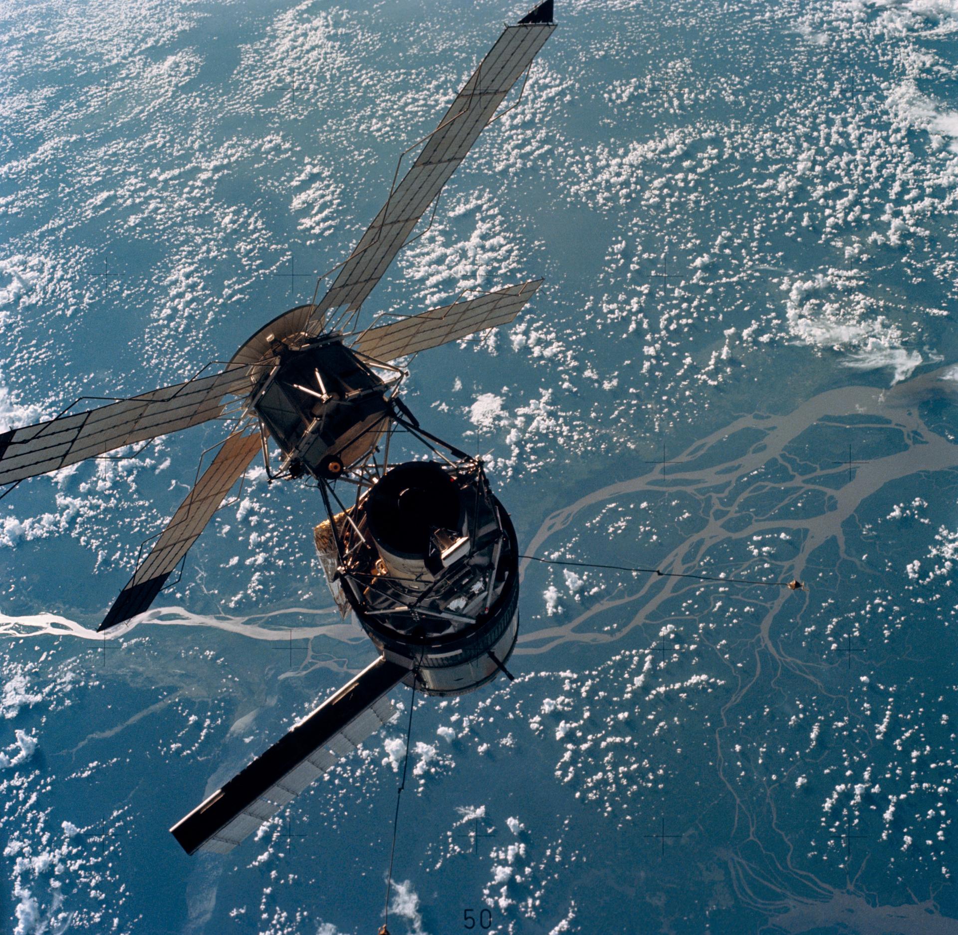 The Skylab space station photographed against an Earth background from the Skylab 3 Command and Service Modules prior to docking on July 28, 1973.
