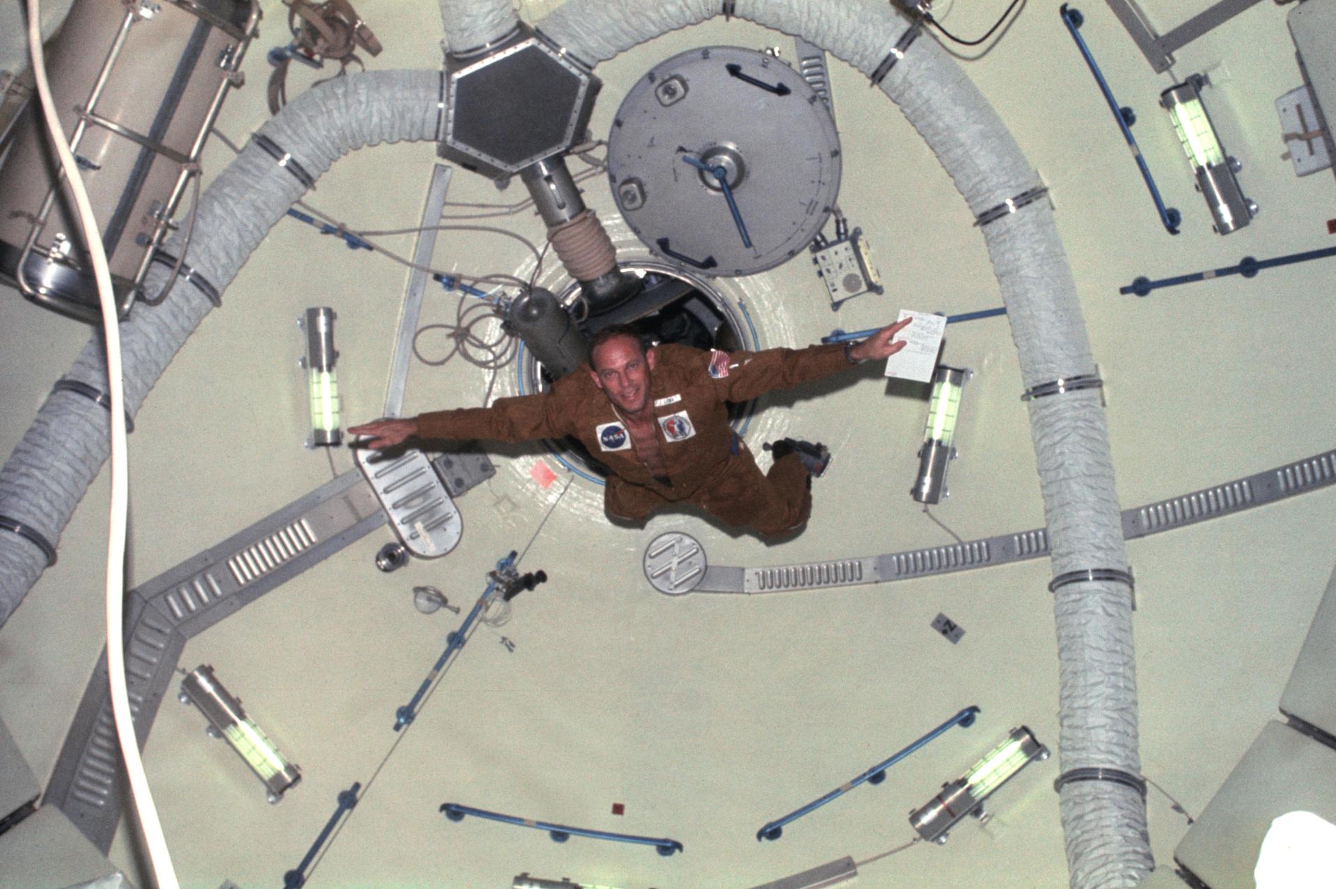 Astronaut Jack R. Lousma, Skylab 3 pilot, doing acrobatics in the Orbital Workshop